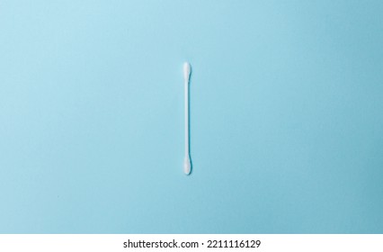 A white cotton swab on a light blue background. Ear stick and cotton swab for cosmetology and hygiene. White cotton buds - Shutterstock ID 2211116129