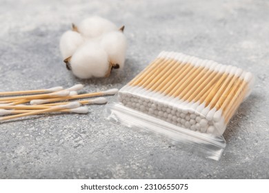 White cotton swabs on a blue textured background. Cotton buds. Bamboo cotton buds. Eco friendly. Hygienic cotton swabs for ears. Place for text. Place to copy.