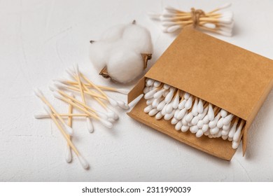 White cotton swabs on concrete texture background. Cotton buds. Bamboo cotton buds. Eco friendly. Hygienic cotton swabs for ears. Place for text. Place to copy.
