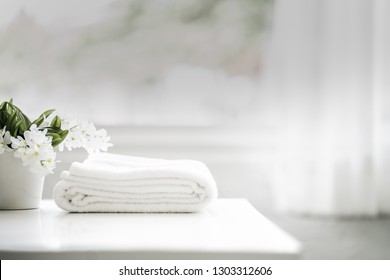 White Cotton Towels On White Counter Table Inside A Bright Bathroom Background. For Product Display Montage