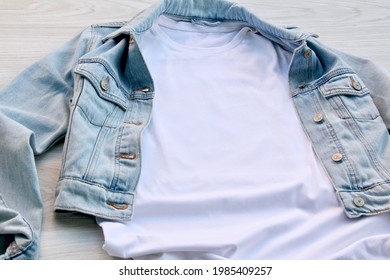 White Cotton T-shirt Mockup With Denim Jacket, On Wooden Floor . Design T Shirt Template, Tee Print Presentation Mock Up