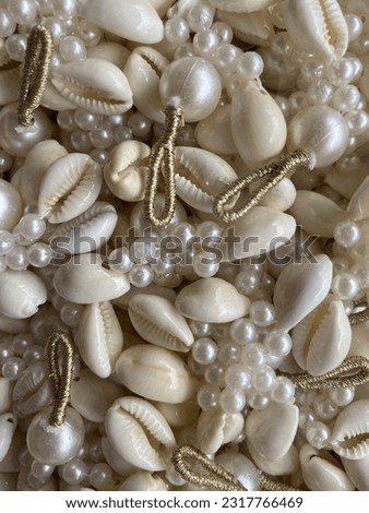 White cowrie with white pearls and golden string latkan