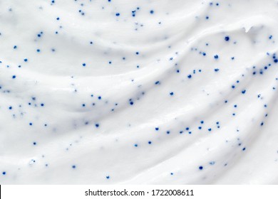 White Cream Scrub Cleanser Background. Skin Care Face Scrub With Blue Particles Texture. Cosmetic Beauty Product Smudge Close Up