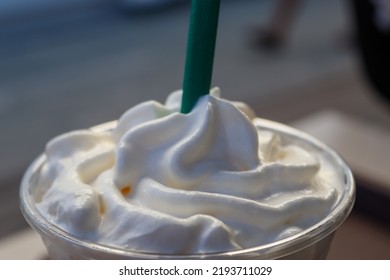 White Creamer And Green Straw On Coffee