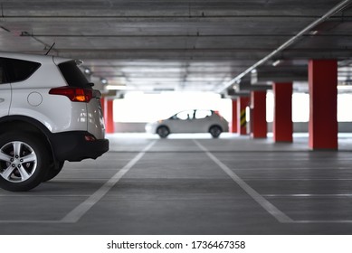 White Crossover Car Parked On Apartment Multi-level Parking