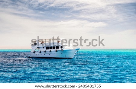 white cruise tourist boat on the background of the coast in the Red Sea in Sharm El Sheikh Egypt