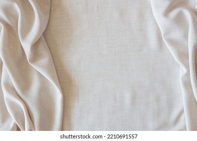 White Crumpled Linen Fabric Texture Background. Natural Off White Wavy Linen Organic Eco Textiles Canvas Background. Top View