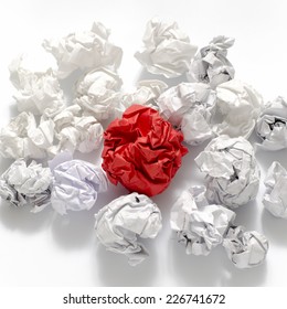 white crumpled paper ball and different red crumpled paper ball on a white background