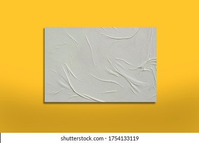 White crumpled sheet of paper on a yellow background.