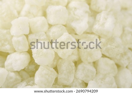 White crystallized winter melon candy pieces coated in sugar, traditional Asian confectionery with translucent appearance and sweet flavor