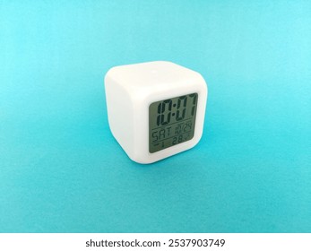 white cube table clock on blue background