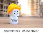 White cubes with hard hat and text SAFETY FIRST. Copy space for text.