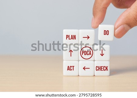 White cubes with Plan, Do, Check, Act text representing the PDCA cycle. Quality management, continuous improvement, and business process concept.