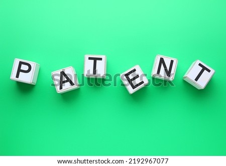 White cubes with word PATENT on green background