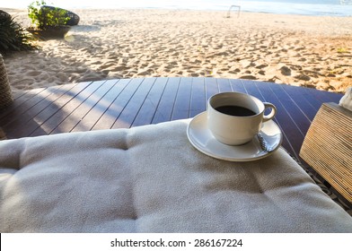 White Cup Of Coffee On Beach