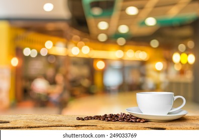 white cup of coffee on wooden bar  in Coffee shop blur background with bokeh image . - Powered by Shutterstock