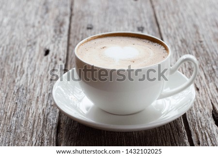 white cup of coffee placed on wooden surface, finished white cup of coffee, close up cup of coffee