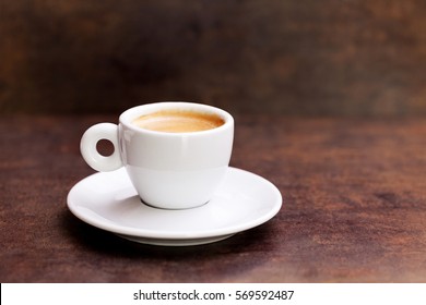 White cup of espresso coffee on background
