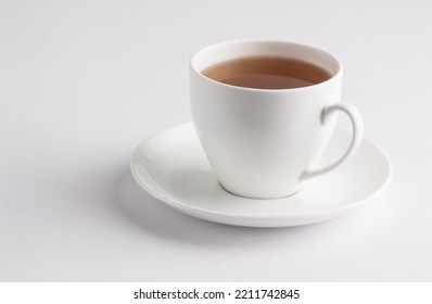 White cup with green tea isolated on a white background - Shutterstock ID 2211742845