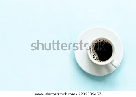 White cup of hot black coffee top view. Coffee break time concept