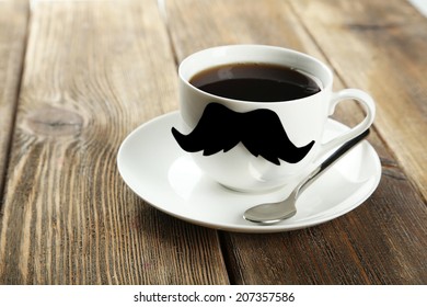 White cup with paper mustache on brown wooden background - Powered by Shutterstock