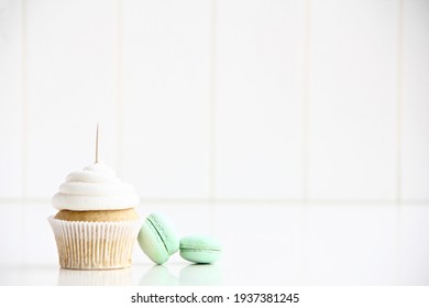 White Cupcake With Topper Stick And Macarons  Mock Up. 