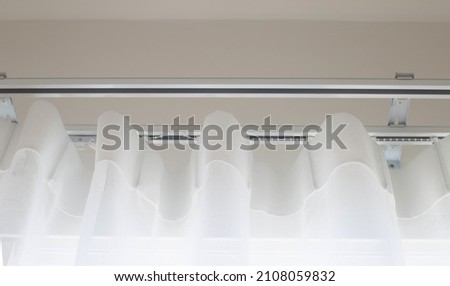 White curtain with curtain rails