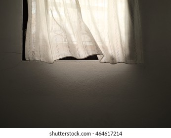 white curtain and window with the wind blowing gently