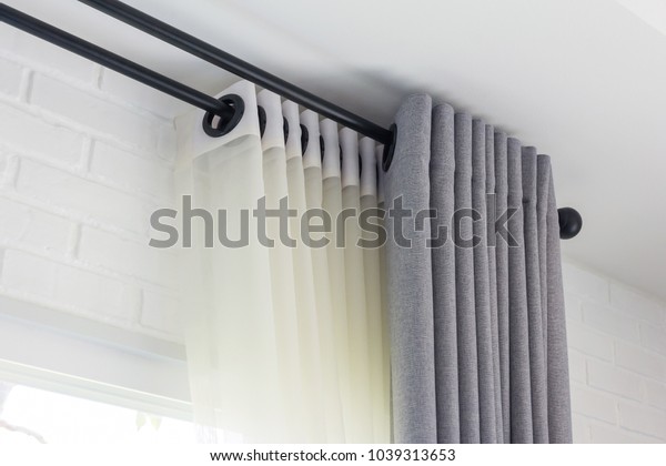The white curtains with ring-top rail,\
Curtain interior decoration in living\
room
