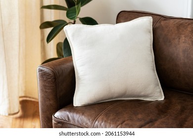 White Cushion On A Leather Couch