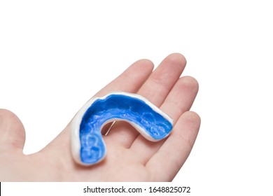 White Custom Sport Mouthguard On A Hand. Individual Professional Sport Equipment.