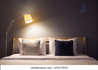 White Cute Bedroom Interior With Lamp And Wooden In Night Time.