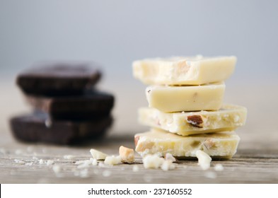 White And Dark Chocolate Piled On A Wooden Table