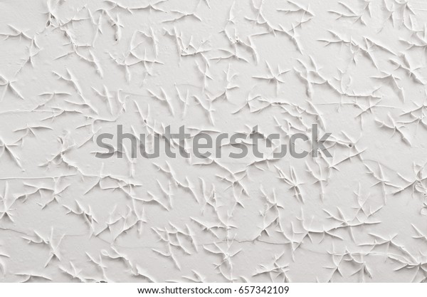 White decorative abstract plaster texture\
with cracks, splash,\
footprints.