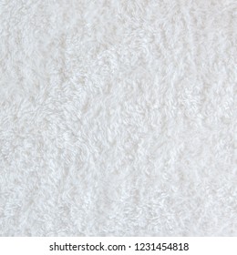 White delicate soft  background of plush fabric. Texture of beige soft fleecy blancet