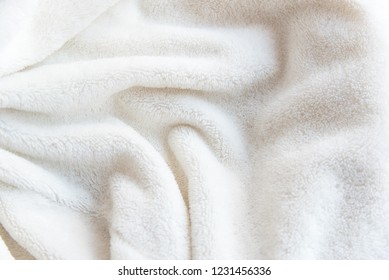 White delicate texture background of plush fabric with soft folds