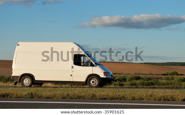 White delivery mini
truck moving on the highway over blue sky. See my portfolio for
trucks and lorries