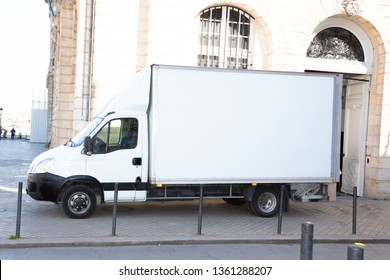 White Delivery Truck With Blank Panel On City Street