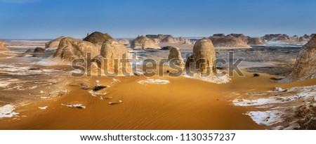 White desert in Egypt, Farafra, wind eroded rock formations at sunset/