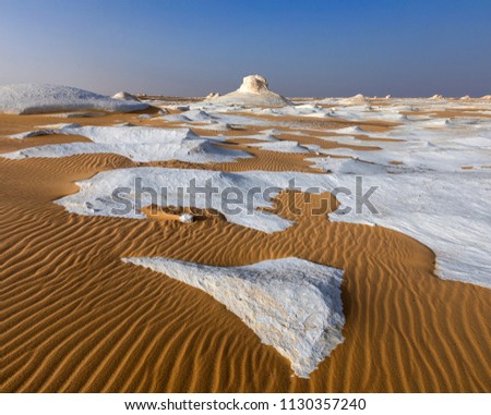White desert in Egypt, Farafra, wind eroded rock formations at sunset/