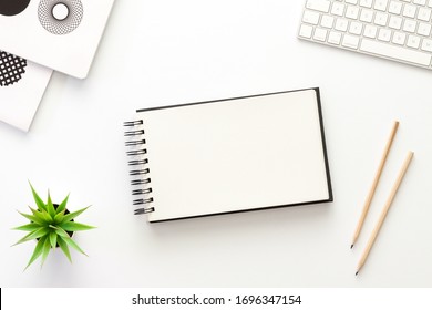 A White Desk With An Open Sketchbook. Mockup.