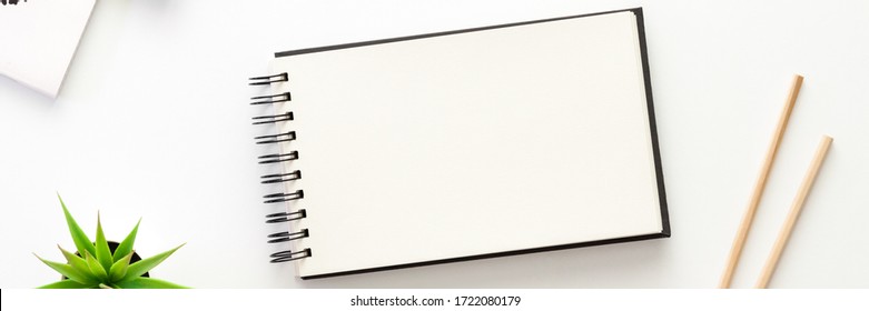 A white desk with an open sketchbook. Mockup. Panorama - Shutterstock ID 1722080179