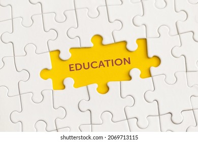 White details of puzzle with the text "Education" on yellow background. 
