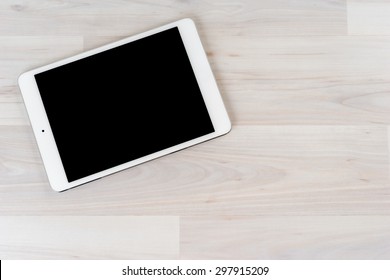 White Digital Tablet On Bright Wooden Table