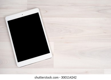 White Digital Tablet On Bright Wooden Table