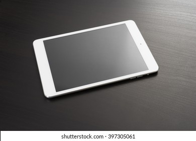 White Digital Tablet On Dark Wooden Table