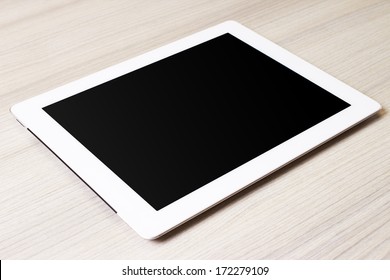 White Digital Tablet On Wooden Table