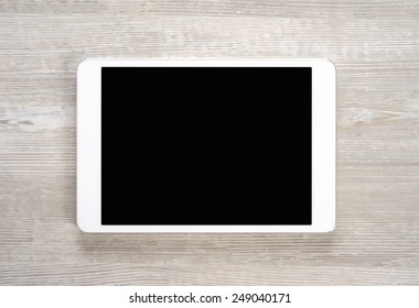 White Digital Tablet On Wooden Table