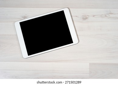 White Digital Tablet On Wooden Table