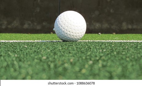 White Dimple Hockey Ball On Astro Turf